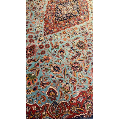 "74-year-old antique Persian Kashan rug with turquoise and red floral patterns, hand-knotted in Iran by Safarzadeh"