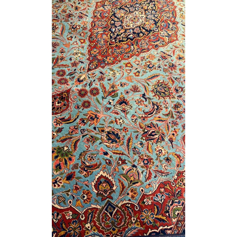 "74-year-old antique Persian Kashan rug with turquoise and red floral patterns, hand-knotted in Iran by Safarzadeh"