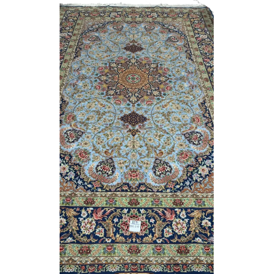 Light blue silk carpet with intricate oriental patterns in green and red hues