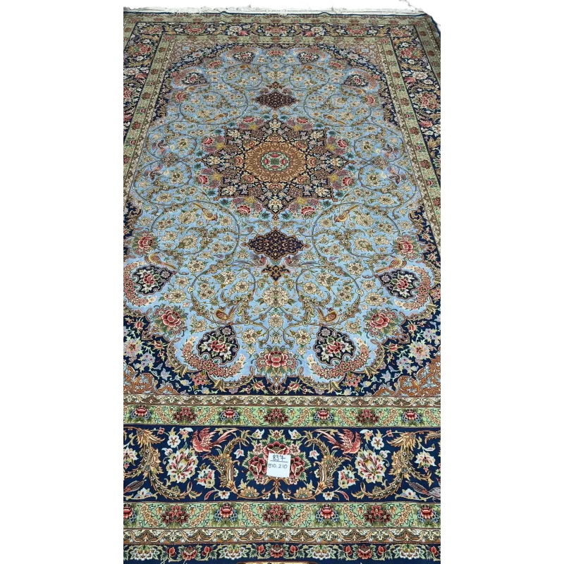 Light blue silk carpet with intricate oriental patterns in green and red hues