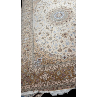 "Luxurious wool and silk Persian rug with intricate floral design in cream and gold tones."