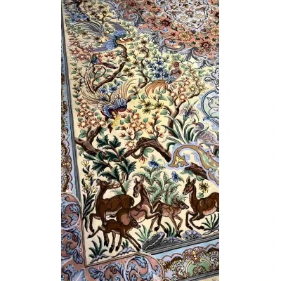 "Exquisite Isfahan silk Persian rug featuring floral and animal motifs, available online."