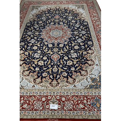 Intricate Floral Borders on Isfahan Carpet – A detailed image highlighting the intricate floral borders of a handmade Isfahan Persian rug, featuring vibrant reds, blues, and golds that contrast with the dark background.