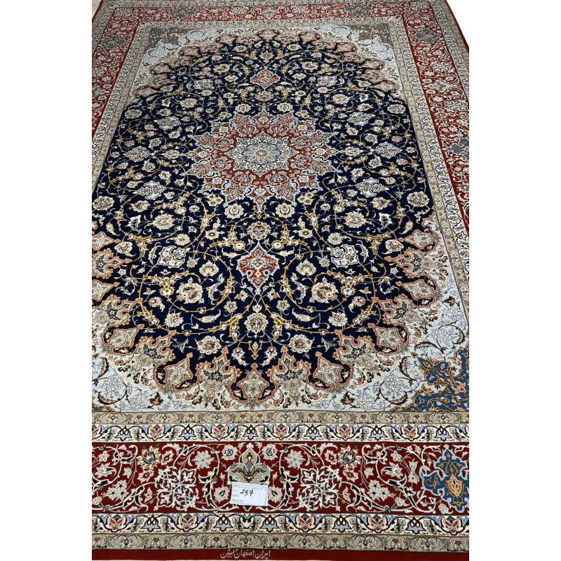 Intricate Floral Borders on Isfahan Carpet – A detailed image highlighting the intricate floral borders of a handmade Isfahan Persian rug, featuring vibrant reds, blues, and golds that contrast with the dark background.