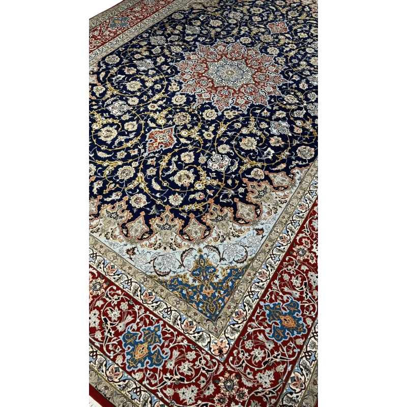 Close-up of Central Medallion on Isfahan Persian Rug – A detailed view of the central medallion on a Persian rug, showcasing vibrant red, blue, and ivory floral motifs, surrounded by intricate curving patterns, meticulously hand-knotted.
