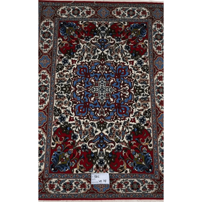 "Hand-knotted Persian rug with intricate floral and geometric designs in red, blue, and cream colors, crafted from wool and silk, showcasing traditional Isfahan craftsmanship, perfect for luxury home decor."






