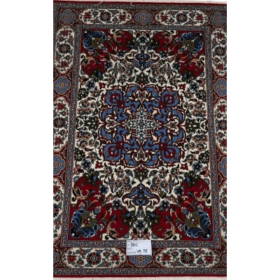 "Hand-knotted Persian rug with intricate floral and geometric designs in red, blue, and cream colors, crafted from wool and silk, showcasing traditional Isfahan craftsmanship, perfect for luxury home decor."






