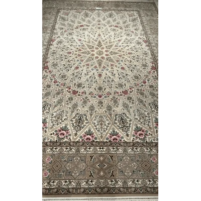 Close-up of the intricate floral patterns on a beige Persian rug