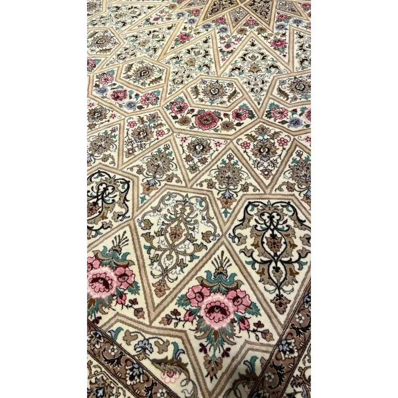Full view of a beige Persian rug with elaborate floral designs