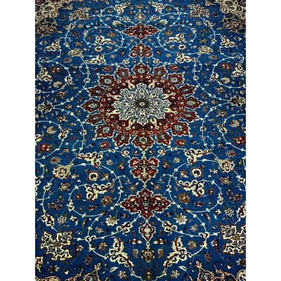 Elegant Floral and Geometric Patterns on Blue Persian Rug – A detailed image capturing the vibrant floral and geometric patterns across the blue field of a Persian rug, bordered by sophisticated accents of red, ivory, and gold, blending traditional artistry with luxurious elegance.