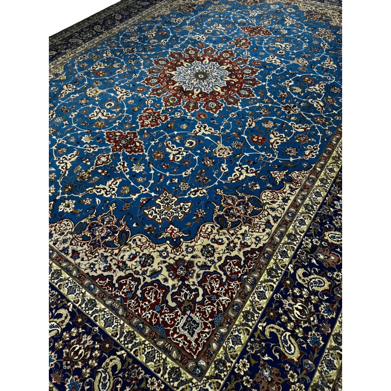 Detailed View of Central Medallion on Blue Persian Rug – A close-up shot of the elaborate central medallion on a Persian rug, showcasing intricate red, ivory, and blue floral designs with fine craftsmanship in the weaving.