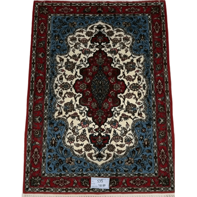 "Hand-knotted Isfahan Persian rug in vibrant red, blue, and ivory tones featuring intricate floral patterns, crafted from silk and wool for a luxurious addition to any home décor."






