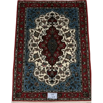 "Hand-knotted Isfahan Persian rug in vibrant red, blue, and ivory tones featuring intricate floral patterns, crafted from silk and wool for a luxurious addition to any home décor."






