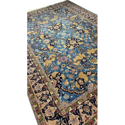 Handwoven Tabriz rug in blue, gold, and pink with natural dyes
