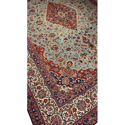 "74-year-old Persian Kashan rug with turquoise and red floral patterns, crafted by Safarzadeh"