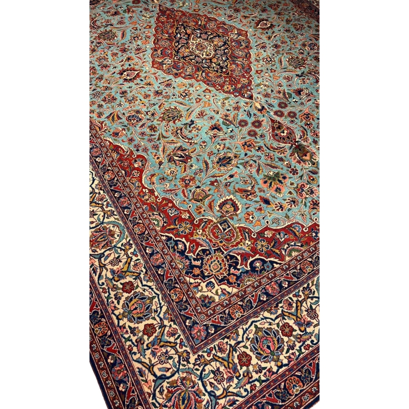 "74-year-old Persian Kashan rug with turquoise and red floral patterns, crafted by Safarzadeh"