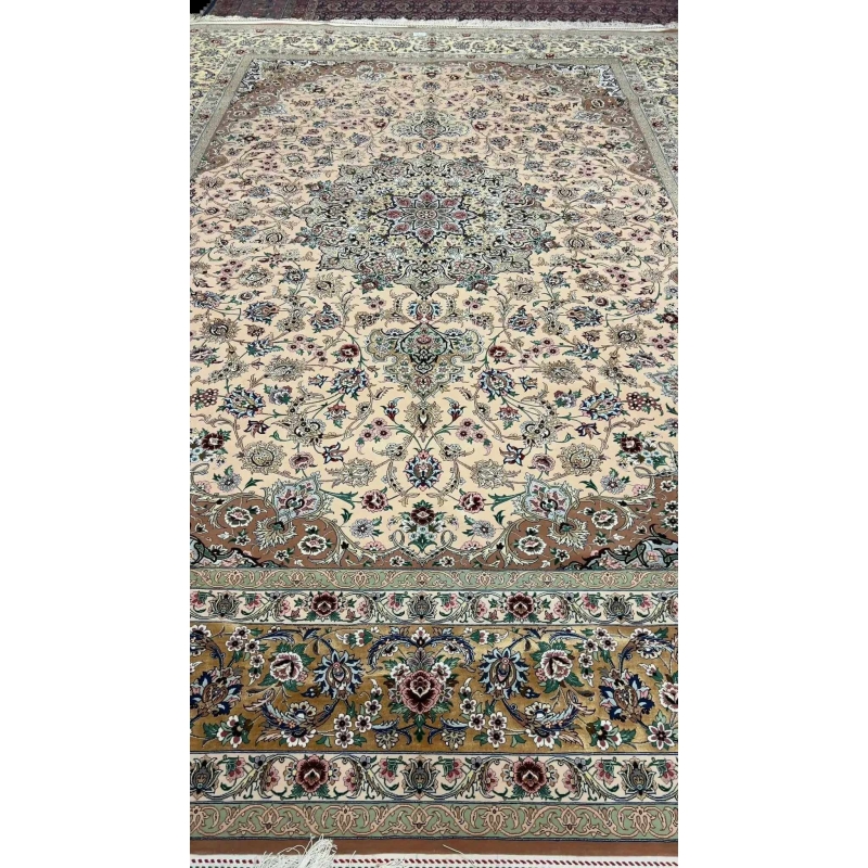 Detailed view of the beige hand-knotted rug from Iran showcasing its floral motifs