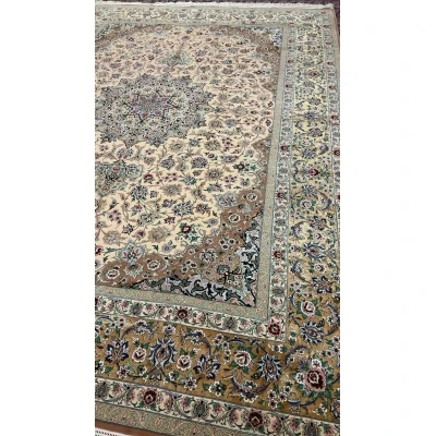 Elegant beige Iranian rug placed on a wooden floor