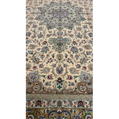 Close-up of the floral design on a beige hand-knotted Iranian rug