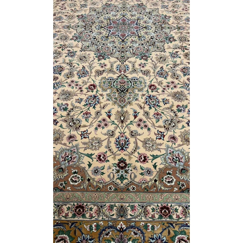 Close-up of the floral design on a beige hand-knotted Iranian rug