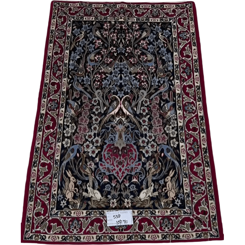 "Hand-knotted Persian rug from Isfahan, made with wool and silk. This luxury rug measures approximately 107 cm x 70 cm (3.5 x 2.3 feet) and features intricate floral and bird designs with a knot density of 810,000 knots per square meter. Perfect for adding sophistication to living spaces."
