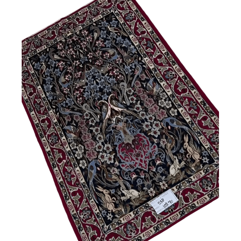 "Elegant handmade Isfahan rug featuring intricate Persian motifs, crafted from wool and silk. The rug measures 107 cm x 70 cm (3.5 x 2.3 feet) and showcases delicate craftsmanship with a soft texture and luxurious feel. A beautiful addition to luxury home décor."