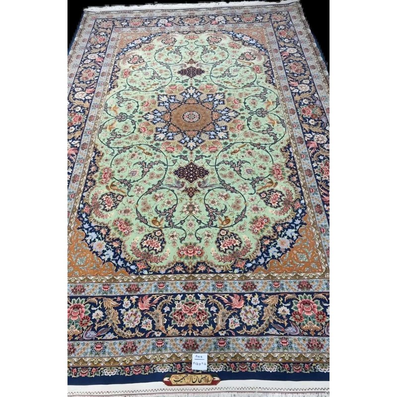 Close-up of the delicate floral patterns on a light green authentic Iranian rug