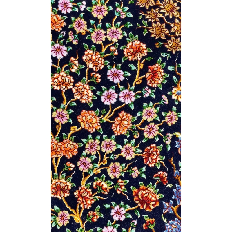 Detailed image of the Tree of Life design on Persian rug against a dark backdrop