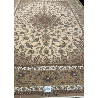 Hand-Knotted Persian Rug by Mohaghegh – 305x205 cm: This hand-knotted Persian rug from Isfahan, featuring a blend of wool and silk in elegant brown and beige tones, is perfect for elevating home interiors. Crafted by master weaver Mohaghegh, it offers luxurious quality and timeless design.

