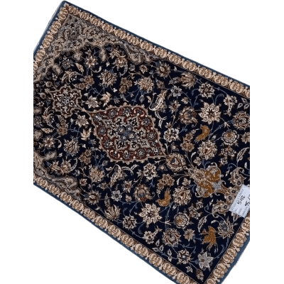 "Hand-knotted Persian carpet from Isfahan, made with wool and silk. This small rug, approximately 70 years old, measures 95 cm x 63 cm (3.1 x 2.1 feet) and showcases traditional craftsmanship, perfect for adding history and elegance to any room."