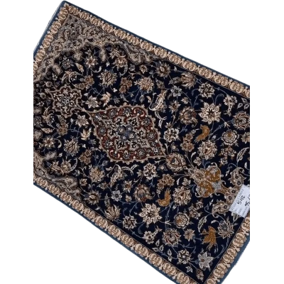 "Hand-knotted Persian carpet from Isfahan, made with wool and silk. This small rug, approximately 70 years old, measures 95 cm x 63 cm (3.1 x 2.1 feet) and showcases traditional craftsmanship, perfect for adding history and elegance to any room."