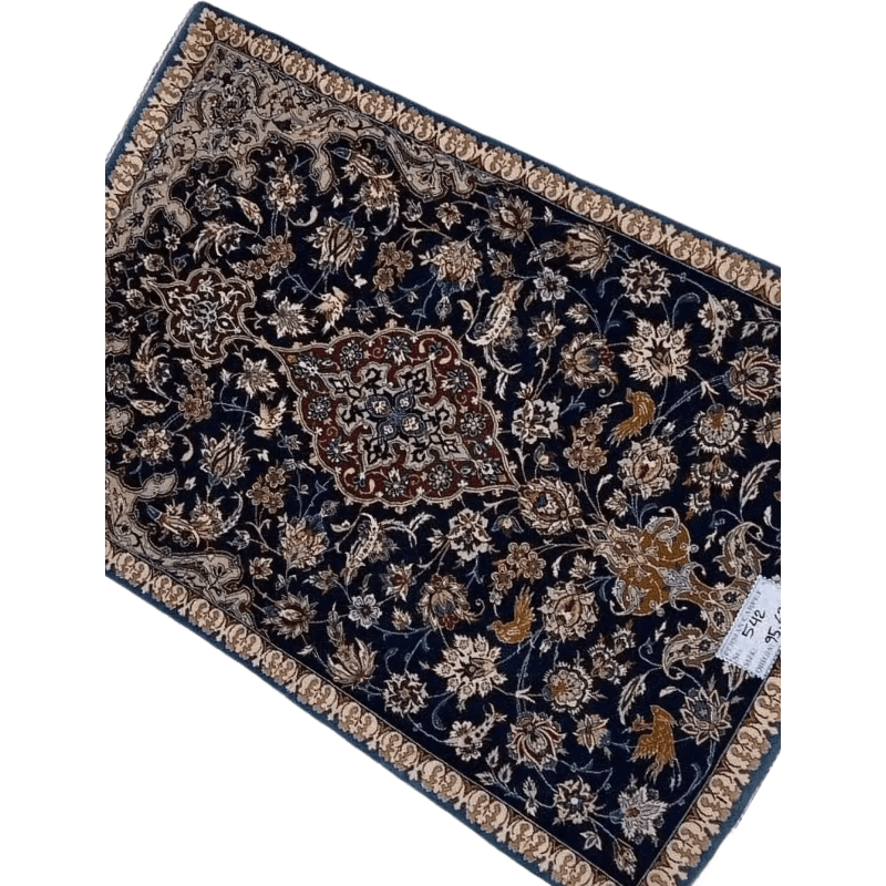 "Hand-knotted Persian carpet from Isfahan, made with wool and silk. This small rug, approximately 70 years old, measures 95 cm x 63 cm (3.1 x 2.1 feet) and showcases traditional craftsmanship, perfect for adding history and elegance to any room."