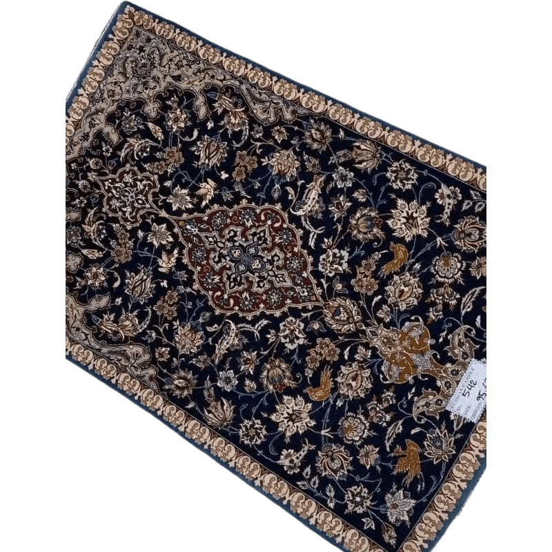 "Hand-knotted Persian carpet from Isfahan, made with wool and silk. This small rug, approximately 70 years old, measures 95 cm x 63 cm (3.1 x 2.1 feet) and showcases traditional craftsmanship, perfect for adding history and elegance to any room."
