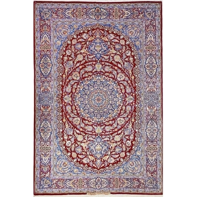 Detailed view of the Isfahan Persian carpet's central medallion with intricate floral patterns in red, blue, and ivory.

