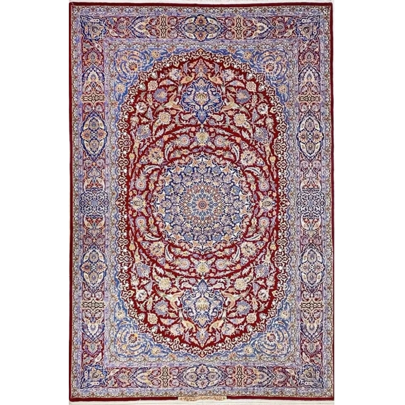 Detailed view of the Isfahan Persian carpet's central medallion with intricate floral patterns in red, blue, and ivory.