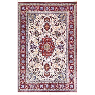 Detailed view of Ghenaat Isfahan handmade rug showcasing intricate floral motifs with red, blue, and cream tones.

