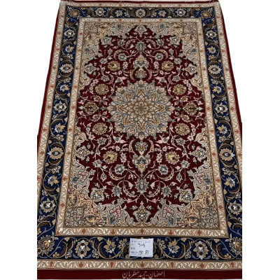 Hand-knotted dark red Persian rug with intricate floral patterns, crafted in Isfahan using wool and silk, designed by master weaver Hamid Atrian.

