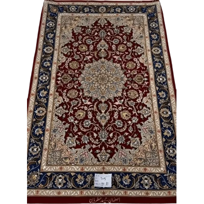 Hand-knotted dark red Persian rug with intricate floral patterns, crafted in Isfahan using wool and silk, designed by master weaver Hamid Atrian.

