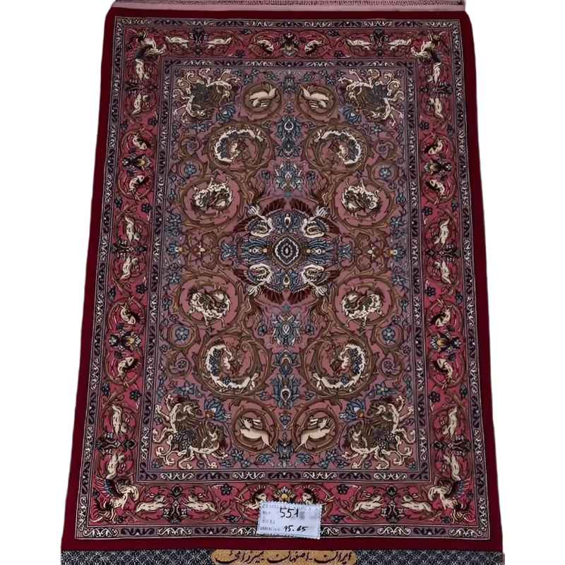 "Hand-knotted Persian rug from Isfahan, 95x65 cm, crafted by Mirzaie with wool and silk, featuring intricate designs and high knot density (810,000 knots/m²). Authentic Persian craftsmanship."
