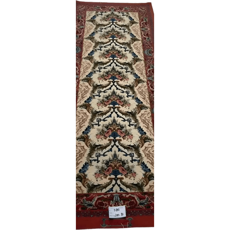 "Vintage-inspired Persian runner rug with red tones, knotted by hand using wool and silk. Dimensions: 200 cm x 80 cm, made in Isfahan, Iran."