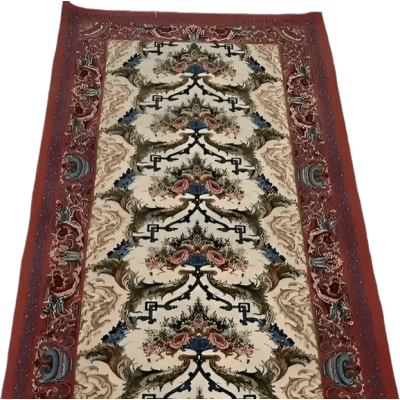 "Elegant Persian-style wool and silk runner rug, hand-crafted in Isfahan, Iran, showcasing classic red patterns and 640,000 knots per square meter."