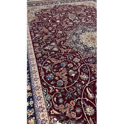 "Luxurious Persian rug featuring a burgundy field and floral motifs with navy and gold accents."