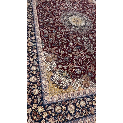 "Close-up of floral and vine patterns on a wool-silk Isfahan rug."